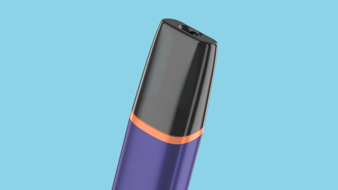 View of the cap of a VEEV ONE vape with a light blue background