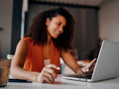 Young woman working on a laptop – Troubleshooting page illustration