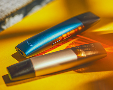 Golden VEEV next to a blue VEEV