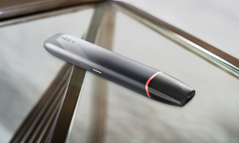 Czarne urządzenie do waporyzacji VEEV inPRIME leżące na szklanym stole