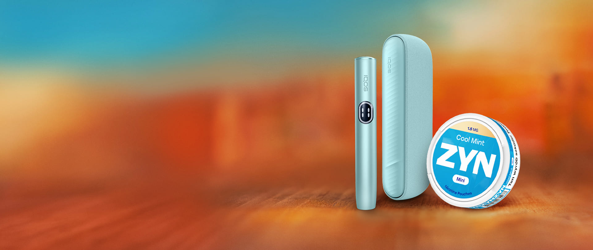 Podgrzewacz tytoniu IQOS ILUMA i w kolorze niebieskim i opakowanie saszetek nikotynowych ZYN Cool Mint w kolorze niebieskim